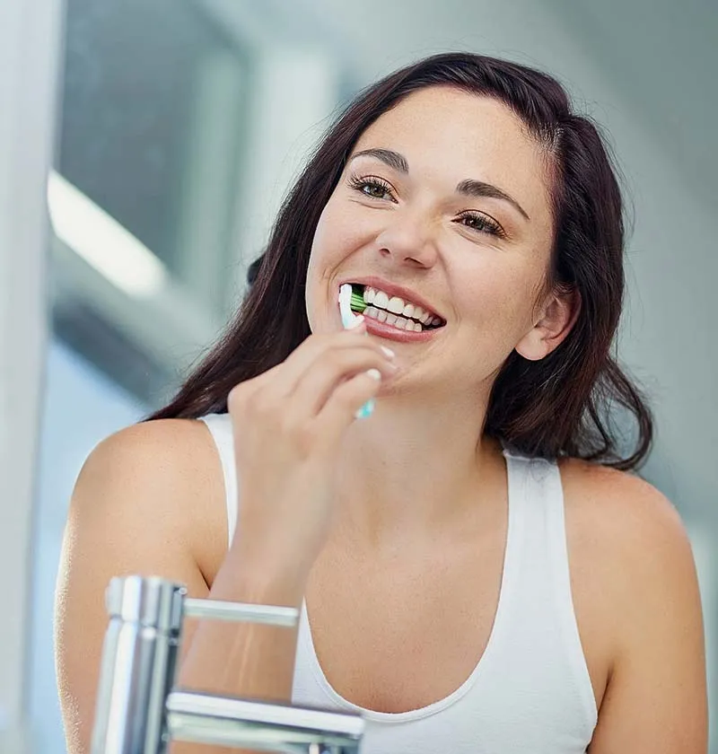 Female brushing her teeth | Dentist in Georgetown